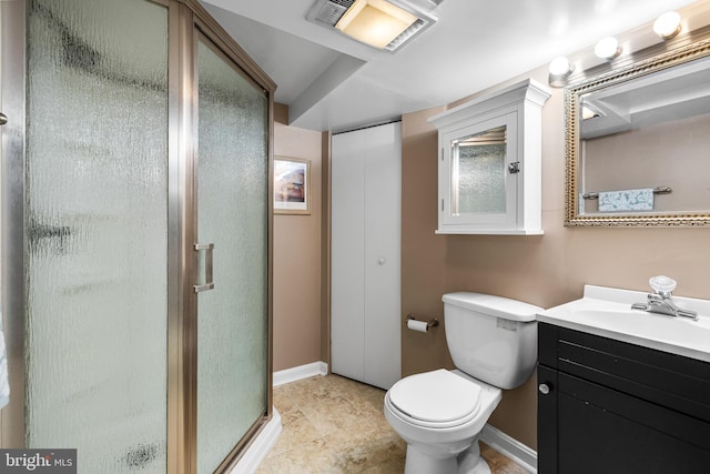 bathroom with vanity, toilet, and a shower with door