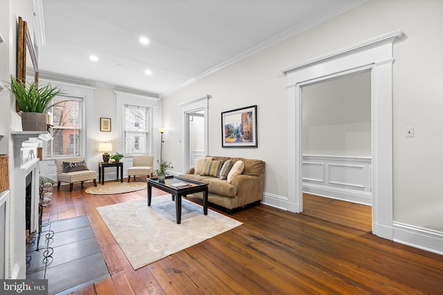 living room with dark hardwood / wood-style flooring and ornamental molding