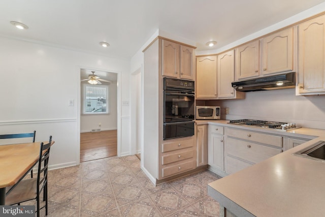 kitchen featuring stainless steel appliances, ceiling fan, ornamental molding, and light brown cabinetry