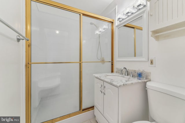 bathroom with an enclosed shower, vanity, and toilet