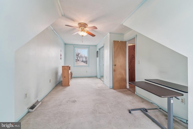 additional living space featuring light colored carpet and ceiling fan