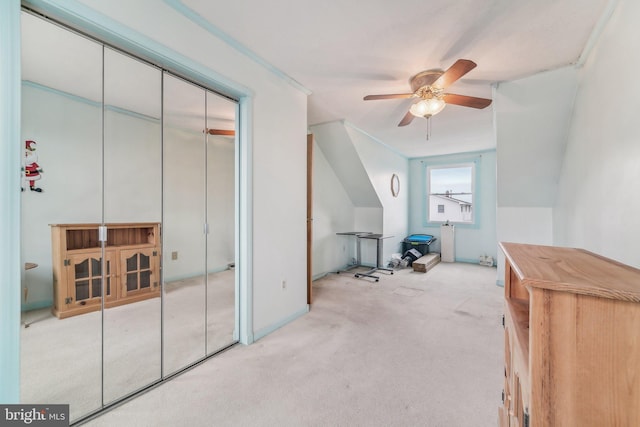 bonus room with light carpet and ceiling fan