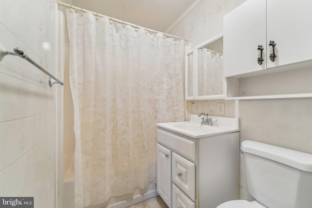 full bathroom with vanity, tile walls, shower / bath combination with curtain, and toilet