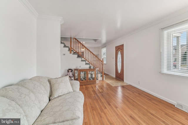 foyer entrance featuring wood-type flooring and ornamental molding