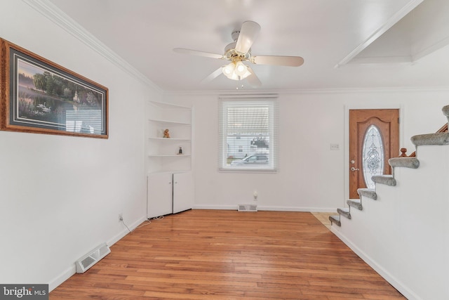 interior space featuring crown molding, ceiling fan, and light hardwood / wood-style floors