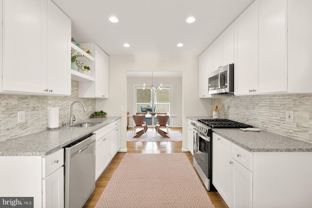 kitchen with sink, white cabinets, and appliances with stainless steel finishes