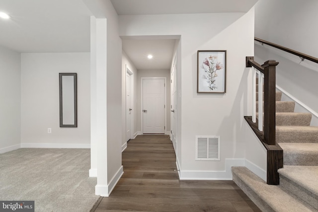 staircase with hardwood / wood-style flooring