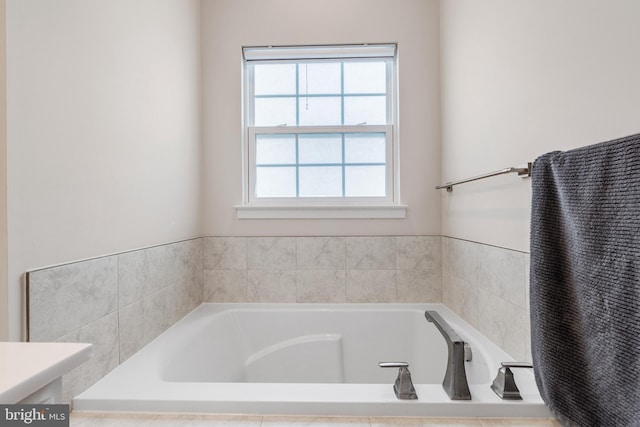 bathroom with a relaxing tiled tub