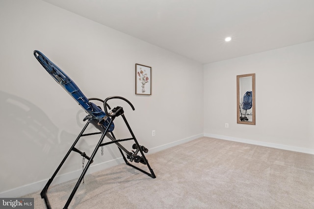 exercise room with light colored carpet