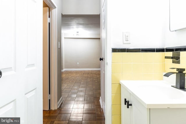 bathroom with sink and tile walls