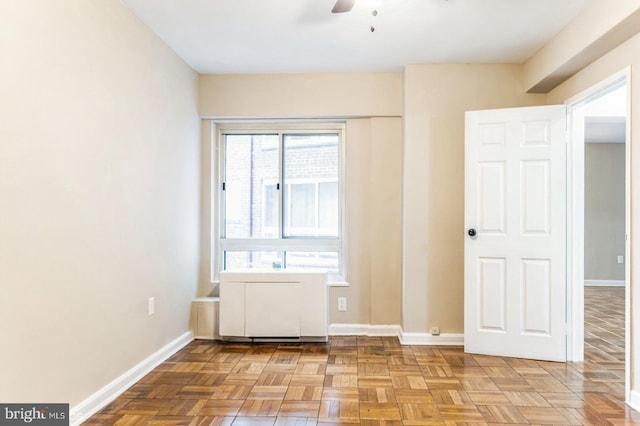 interior space with ceiling fan and light parquet floors