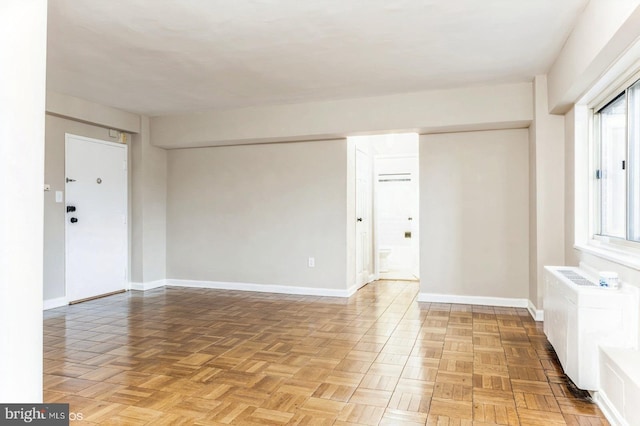 unfurnished room with parquet floors