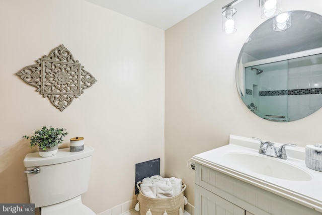 bathroom featuring vanity, an enclosed shower, and toilet