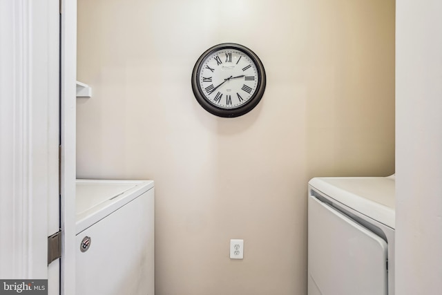 clothes washing area with washer and clothes dryer