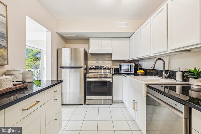 kitchen with white cabinetry, sink, light tile patterned flooring, and appliances with stainless steel finishes