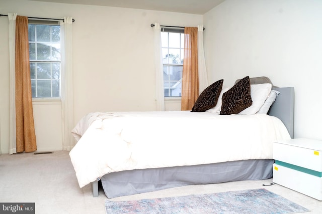 bedroom featuring light carpet