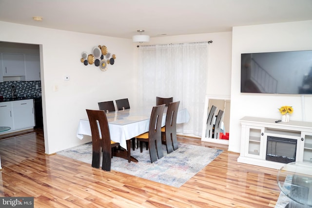 dining area featuring hardwood / wood-style flooring and sink