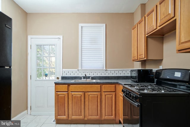 kitchen with tasteful backsplash, sink, and black appliances