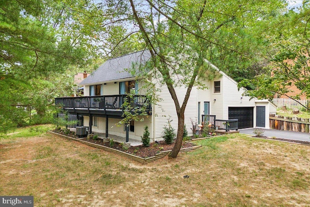 rear view of property with a yard and a garage