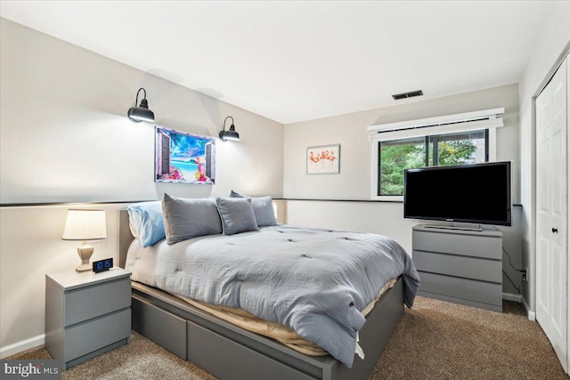 bedroom with dark carpet and a closet