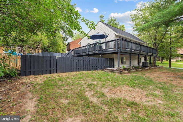 view of yard featuring a wooden deck and central AC