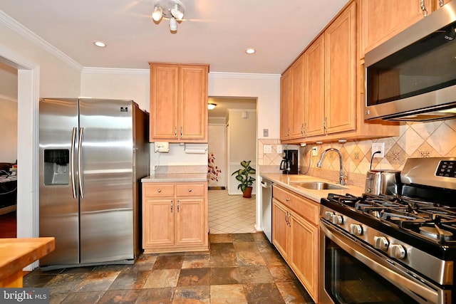 kitchen with tasteful backsplash, ornamental molding, stainless steel appliances, and sink