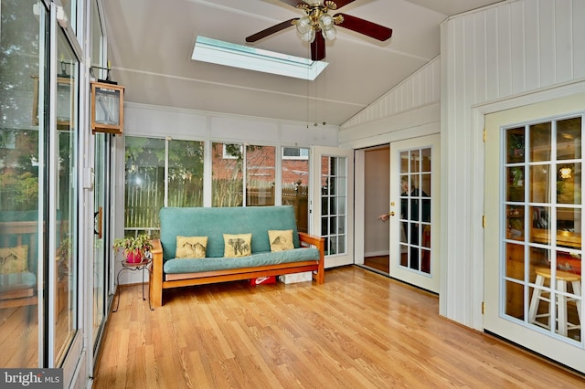 sunroom / solarium featuring lofted ceiling with skylight and ceiling fan