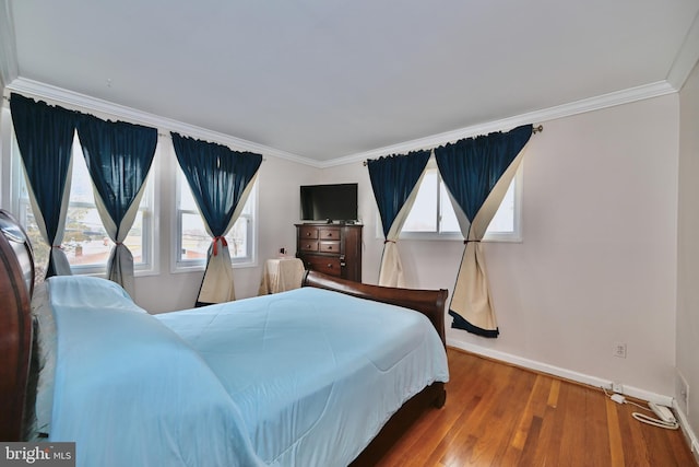 bedroom featuring hardwood / wood-style flooring and crown molding