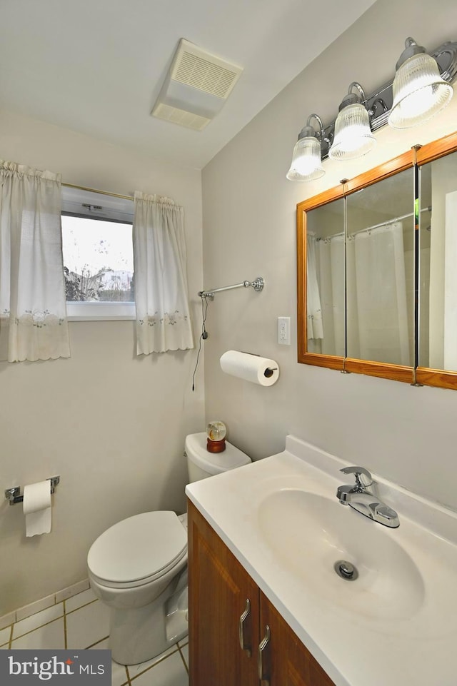 bathroom with vanity, toilet, curtained shower, and tile patterned flooring