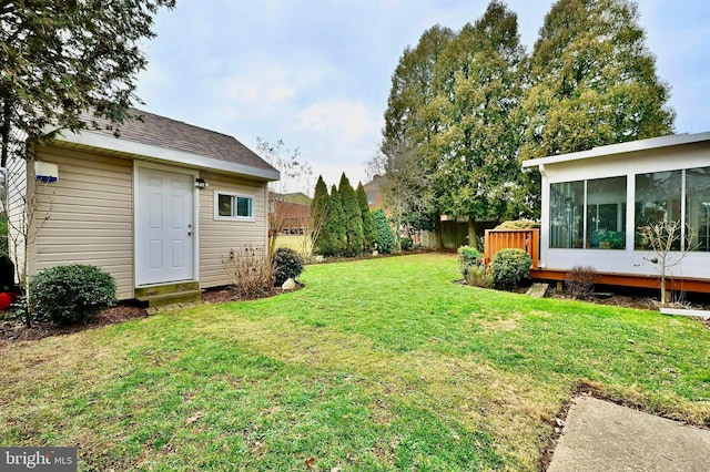 view of yard with an outdoor structure and a sunroom