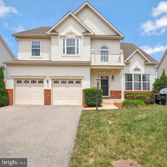 view of front of property featuring a garage and a front yard