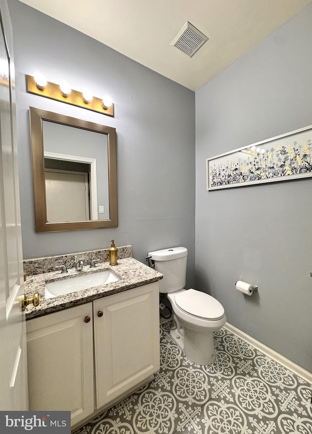 bathroom with vanity, tile patterned floors, and toilet