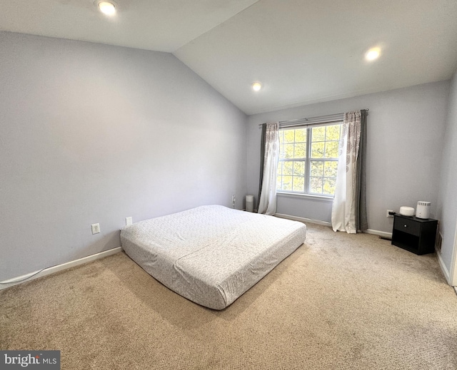 carpeted bedroom featuring vaulted ceiling