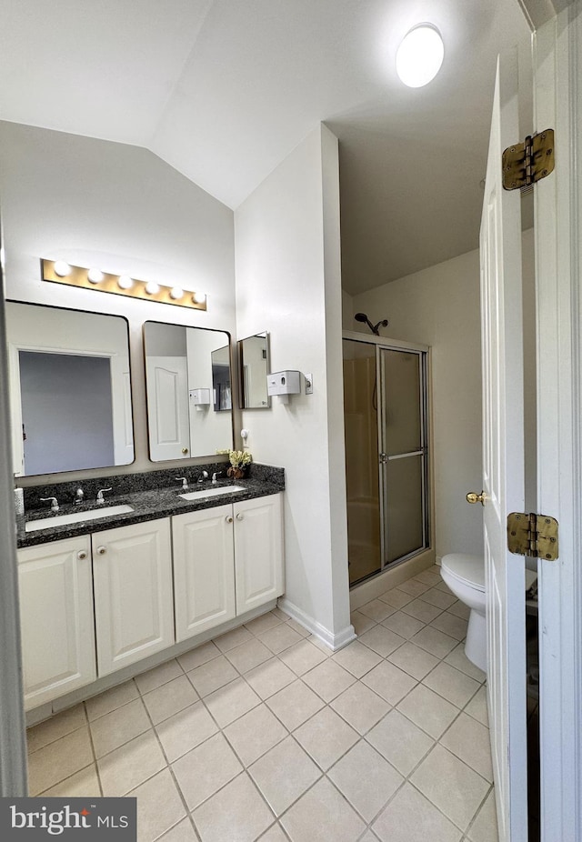 bathroom featuring lofted ceiling, tile patterned flooring, vanity, a shower with shower door, and toilet