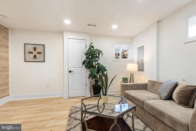 living room with hardwood / wood-style flooring and electric panel