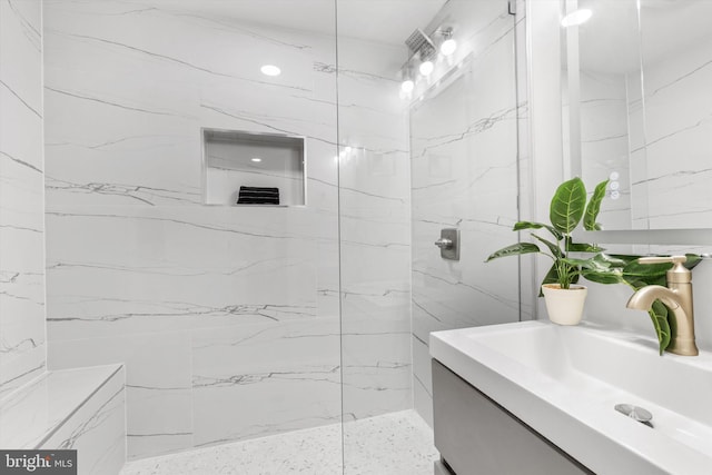 bathroom featuring vanity and tiled shower