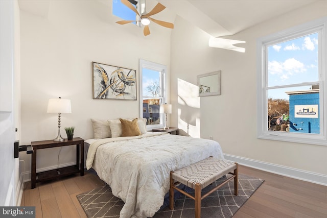 bedroom featuring dark hardwood / wood-style floors and multiple windows