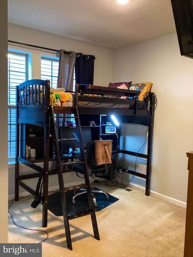 carpeted bedroom featuring baseboards