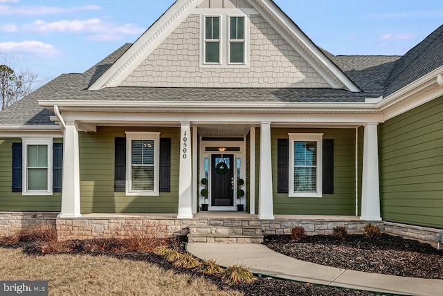 view of exterior entry featuring covered porch