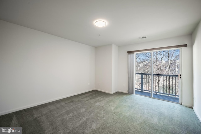 spare room with dark colored carpet