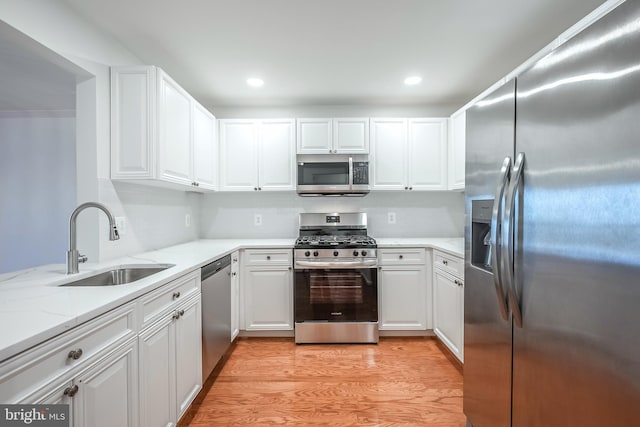 kitchen featuring white cabinetry, sink, and appliances with stainless steel finishes