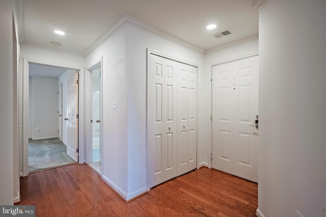 hallway featuring crown molding and hardwood / wood-style floors