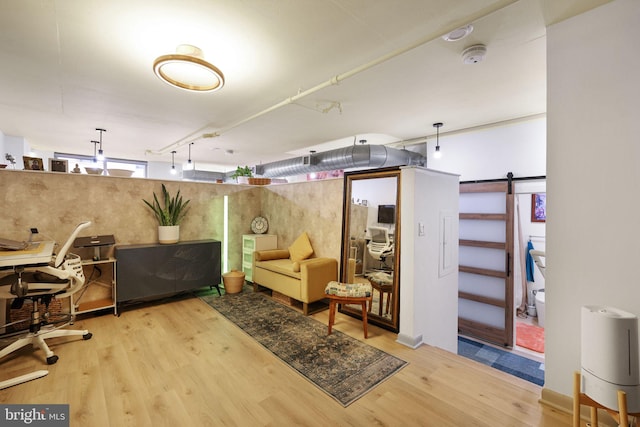 interior space with hardwood / wood-style flooring and a barn door