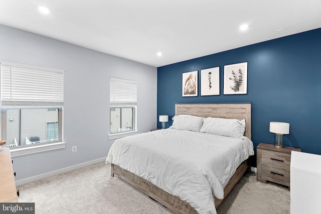 bedroom featuring recessed lighting, light colored carpet, and baseboards