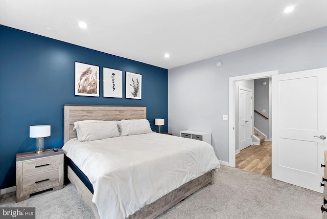 bedroom with recessed lighting, light carpet, and baseboards