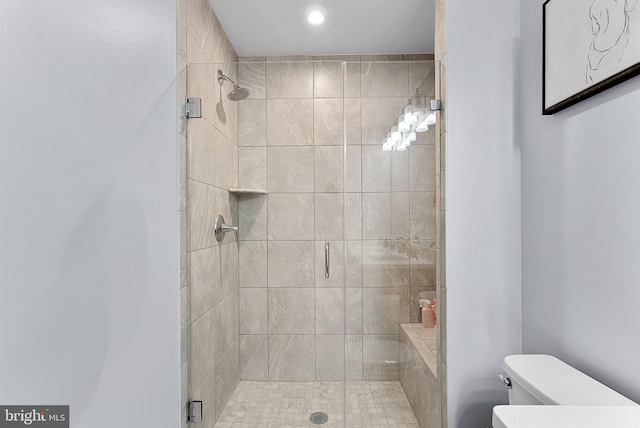 bathroom with toilet and a shower stall