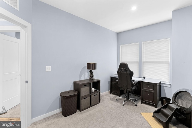 office area featuring light carpet, visible vents, and baseboards