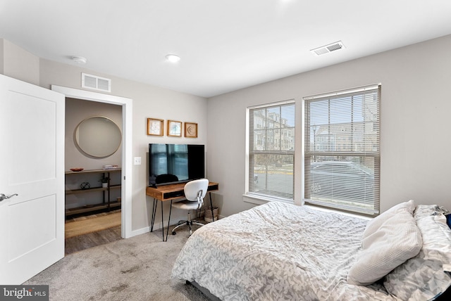 carpeted bedroom with baseboards and visible vents