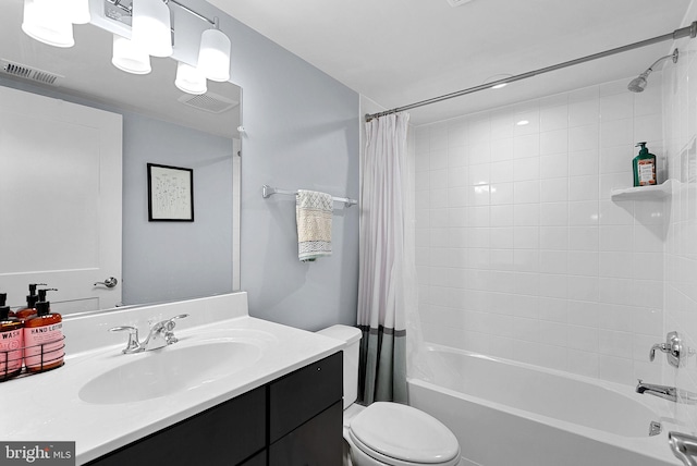 bathroom featuring shower / bath combination with curtain, visible vents, vanity, and toilet