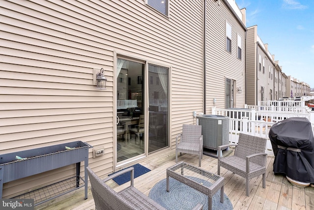 deck featuring grilling area and central air condition unit